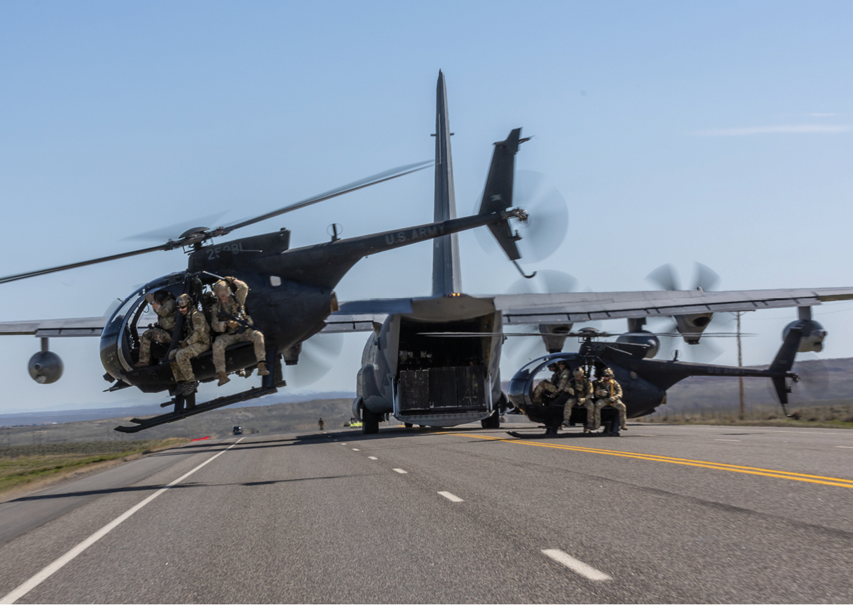 A helicopter is flying over a road with two trucks. Description generated by AI