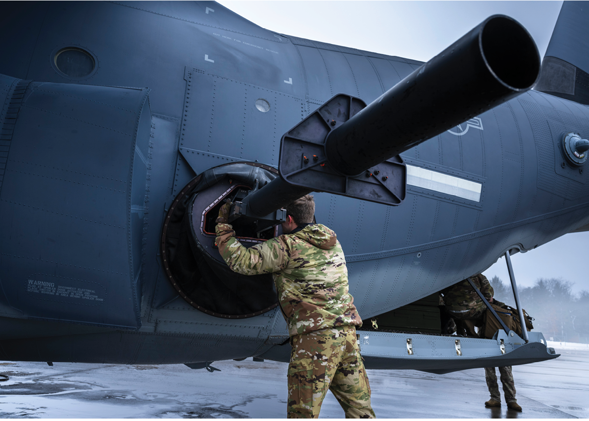 A man is holding a pipe up to a helicopter. Description generated by AI