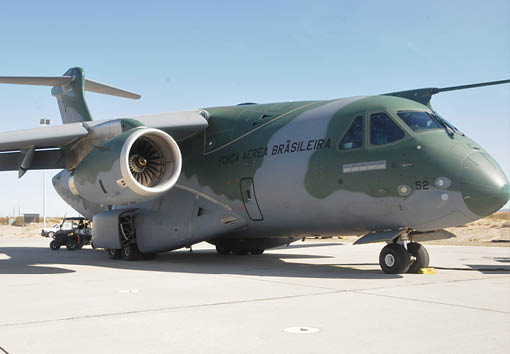 A large green airplane with a propeller on the front. Description generated by AI