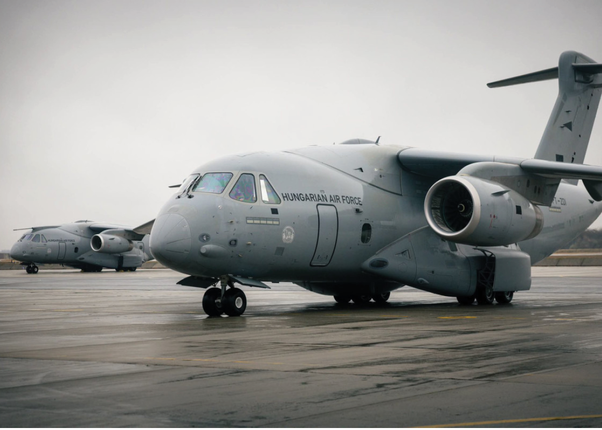 A silver military plane with a jet engine on the back. Description generated by AI