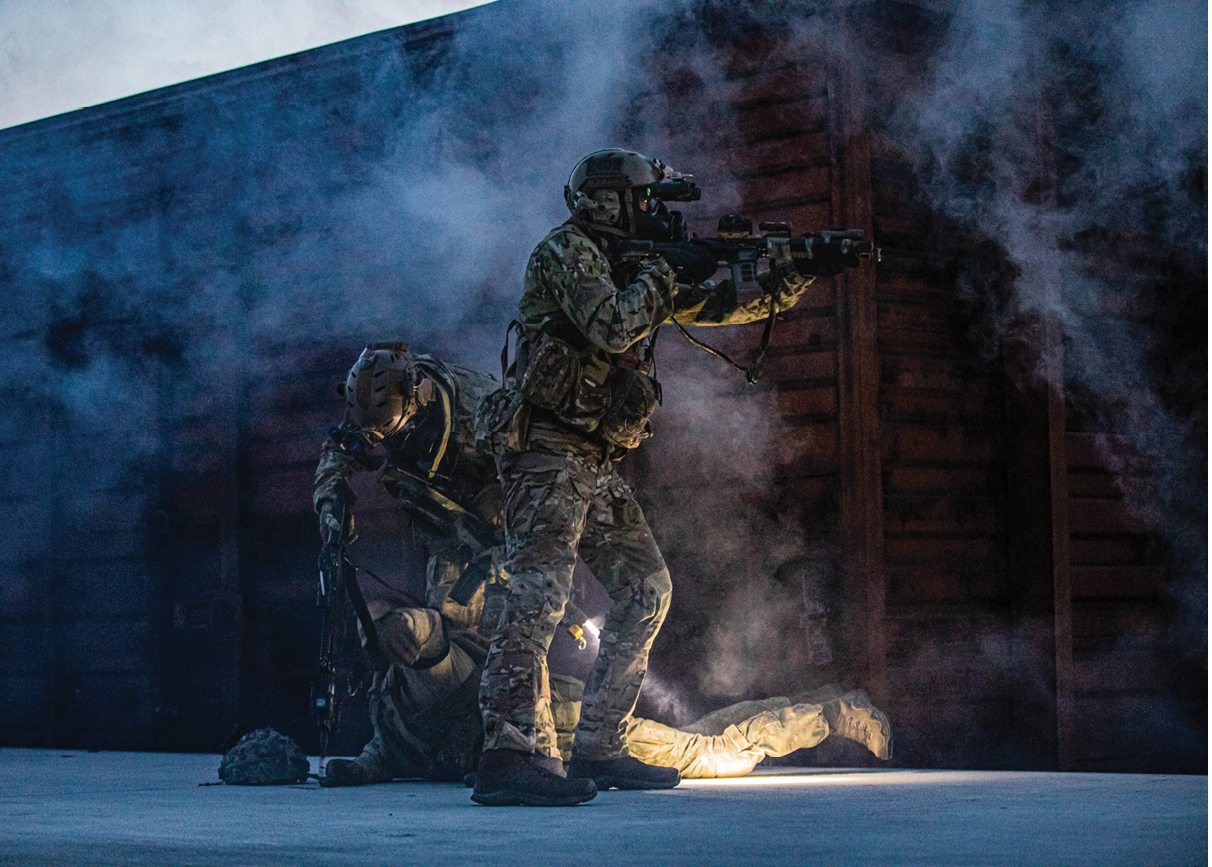 Two men in camouflage uniforms are playing a game. Description generated by AI