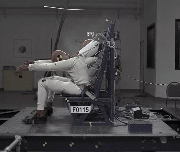 A man is sitting in a chair with a number plate on it. Description generated by AI