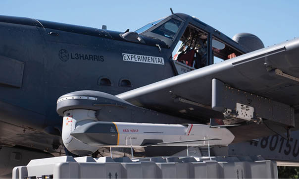 A small plane with a missle on the back. Description generated by AI