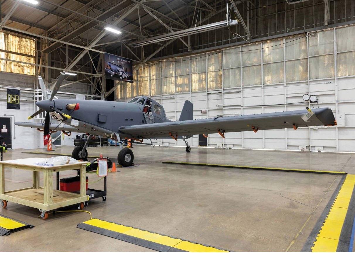 A gray airplane is parked in a hangar. Description generated by AI