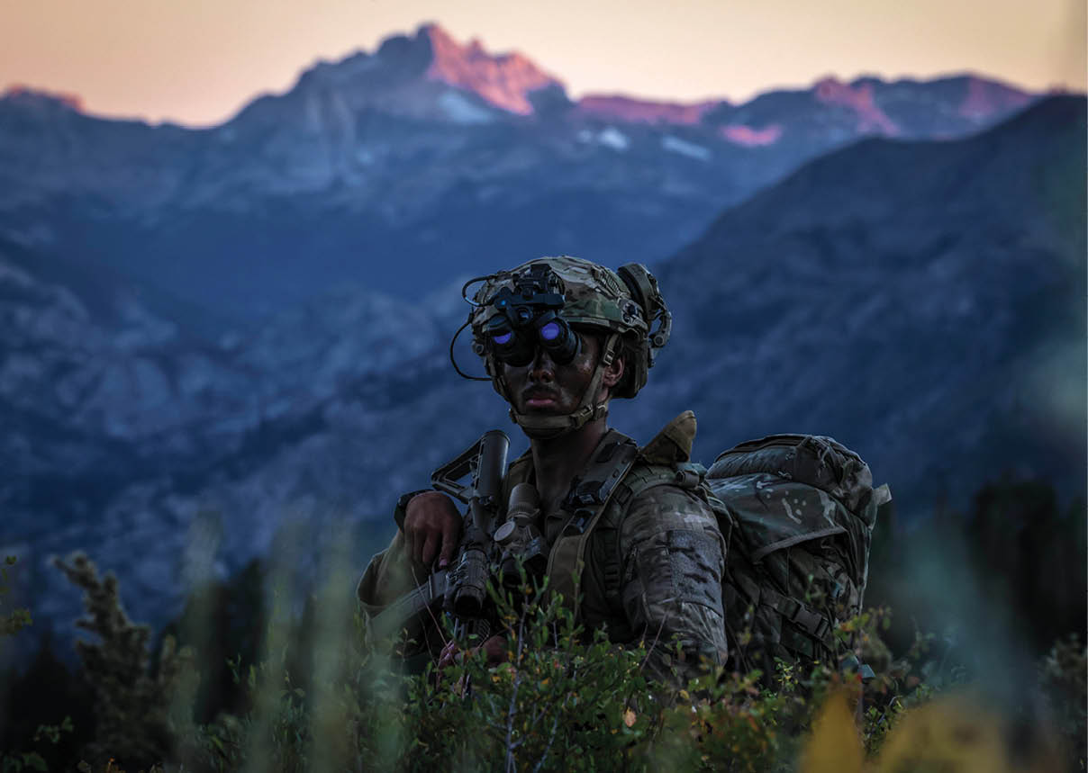 A man wearing a camouflage uniform and a helmet. Description generated by AI