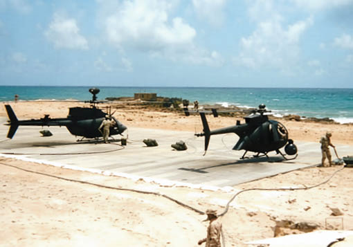 Two helicopters are parked on a runway. Description generated by AI
