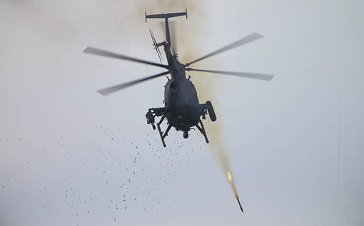 A helicopter is flying through the air and shooting a missile. Description generated by AI