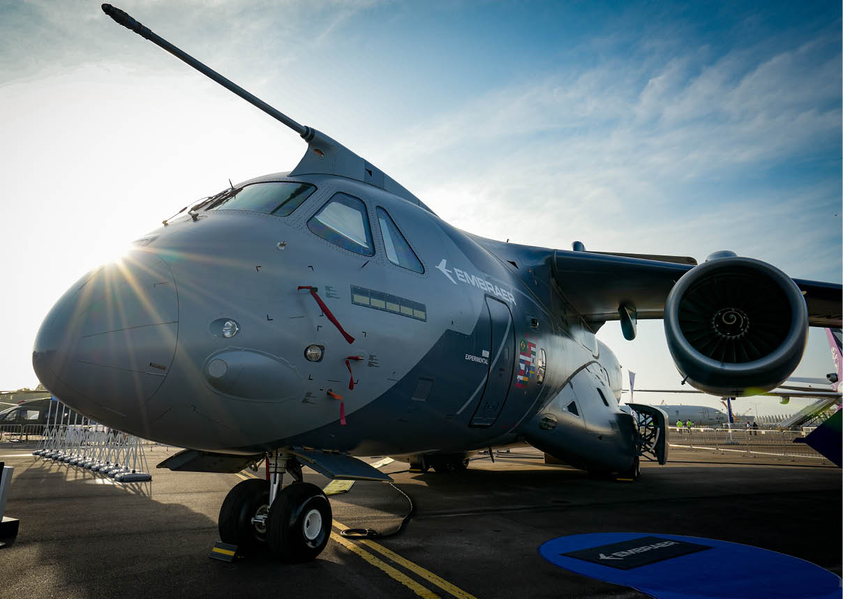 A large grey airplane with a blue stripe on the side. Description generated by AI