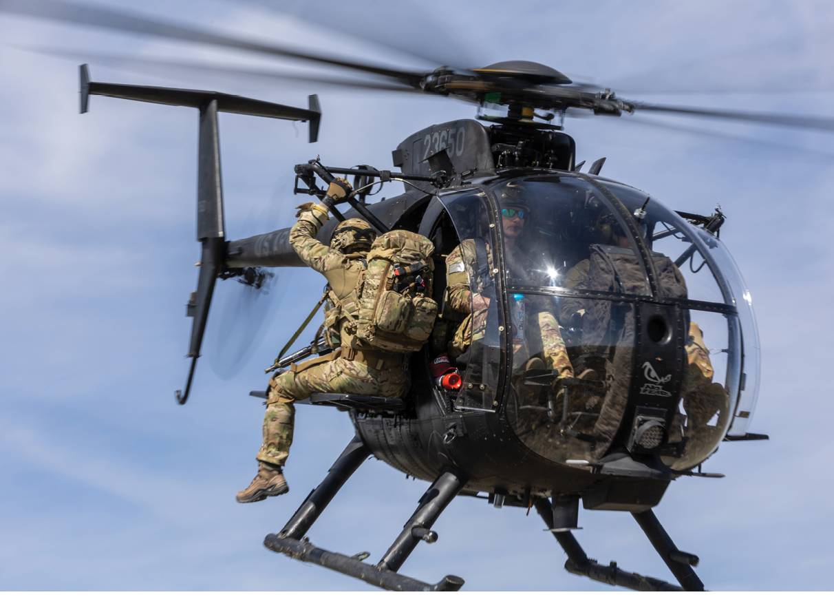 A helicopter with two men in it. Description generated by AI