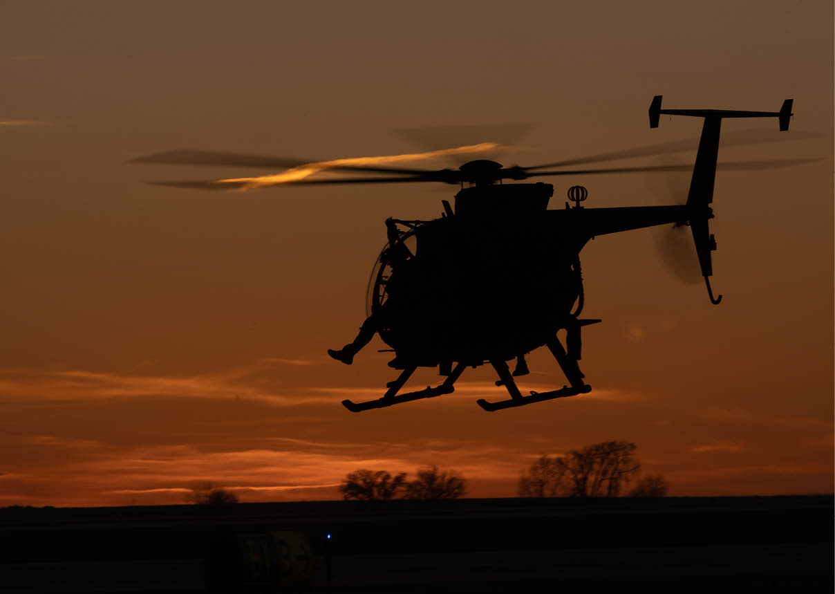 A helicopter flying in the sky. Description generated by AI