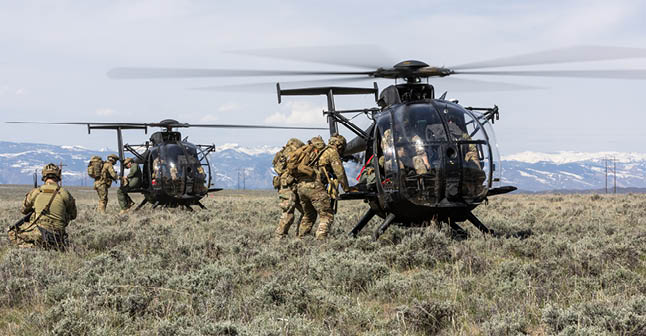 Three helicopters in a field. Description generated by AI