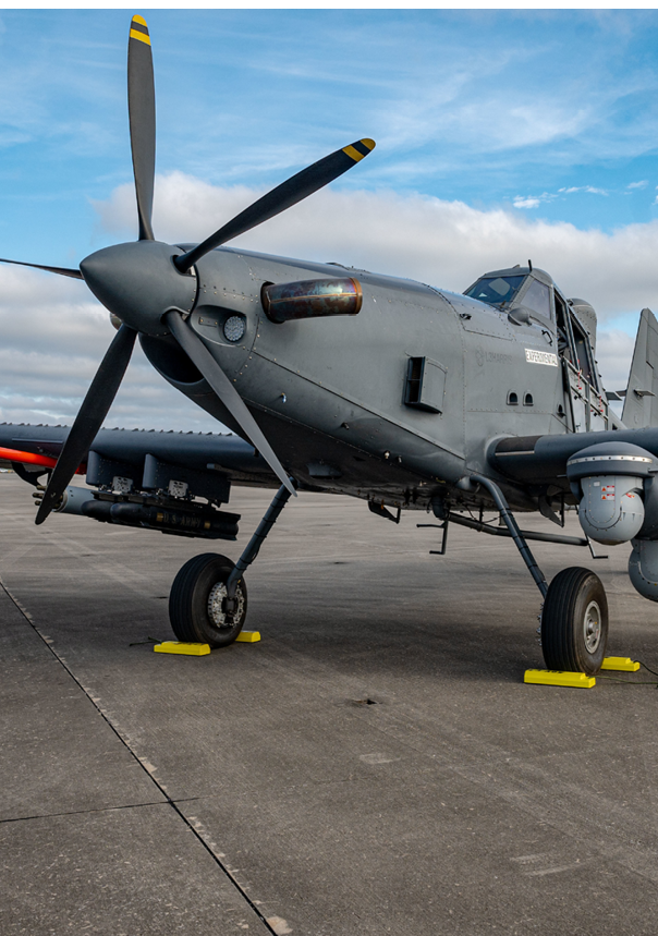 A grey airplane with a propeller on the front. Description generated by AI