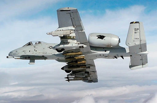 A fighter jet with missiles attached. Description generated by AI