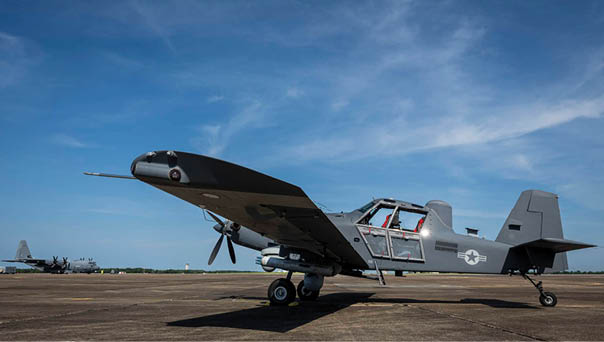 A small airplane with a propeller is parked on the ground. Description generated by AI
