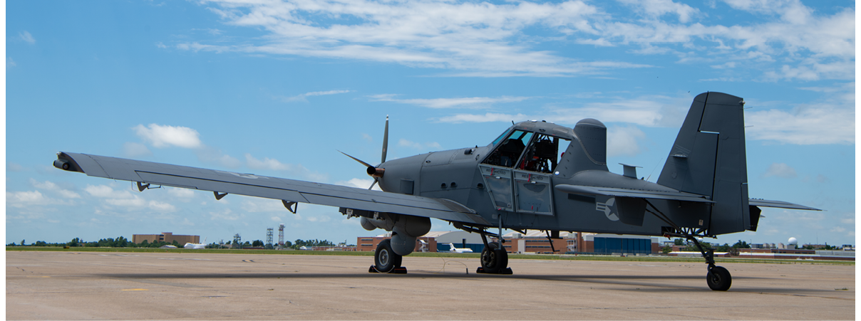 A small airplane is parked on the tarmac. Description generated by AI