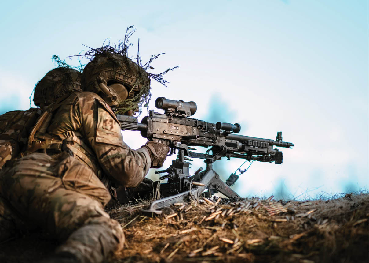 A man in a camouflage uniform is holding a gun. Description generated by AI