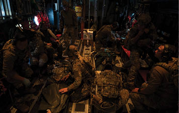 A group of soldiers are in a room, some sitting and some standing. Description generated by AI