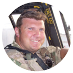 A man wearing a camouflage uniform is sitting in a helicopter, smiling and posing for a picture. AI generated content