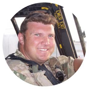 A man wearing a camouflage uniform is sitting in a helicopter, smiling and posing for a picture. AI generated content