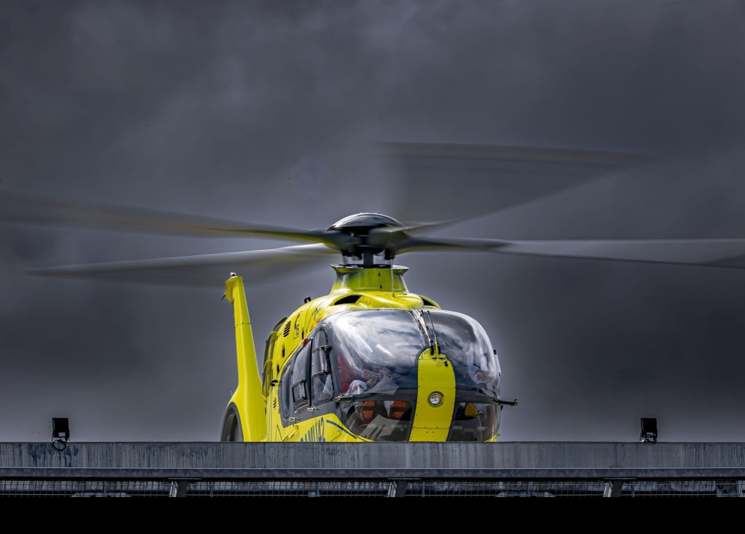 A yellow helicopter with a black top is flying in the air. AI generated content