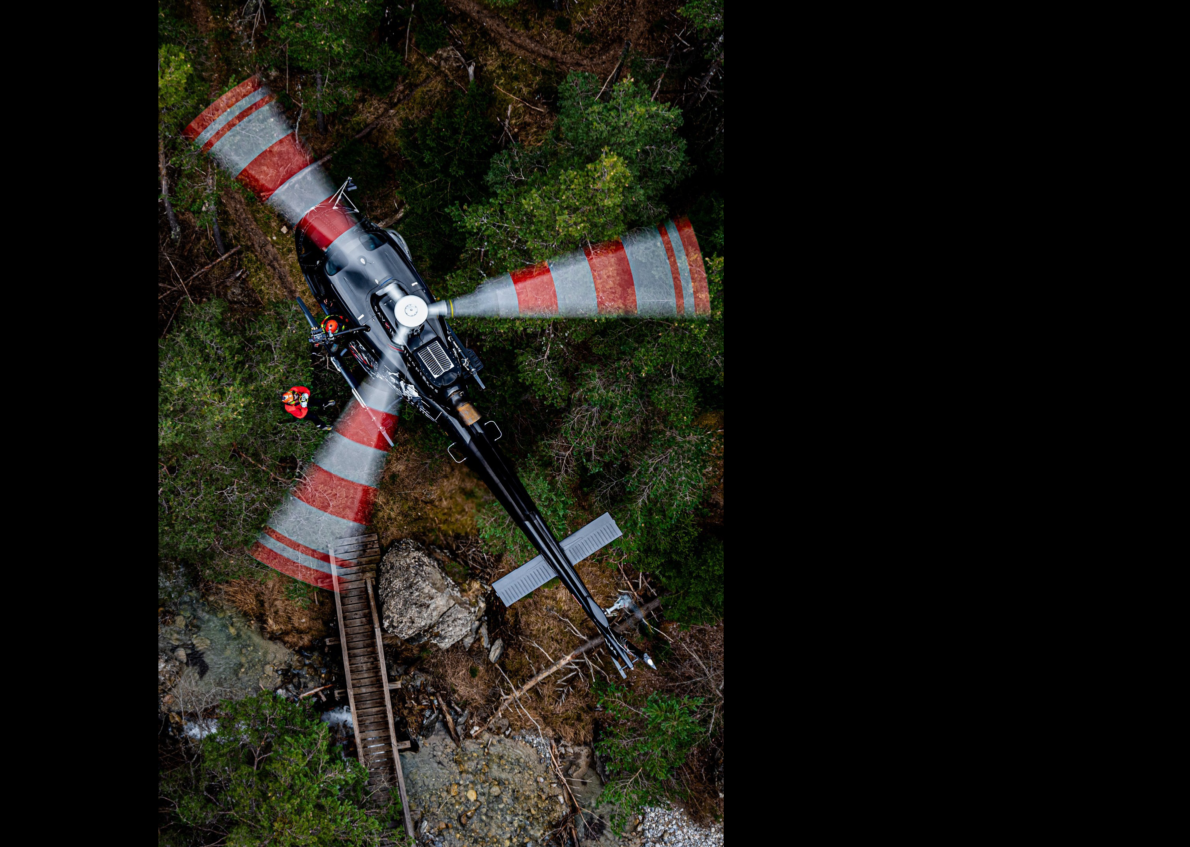 A helicopter with a red and white tail is flying over a forest. AI generated content