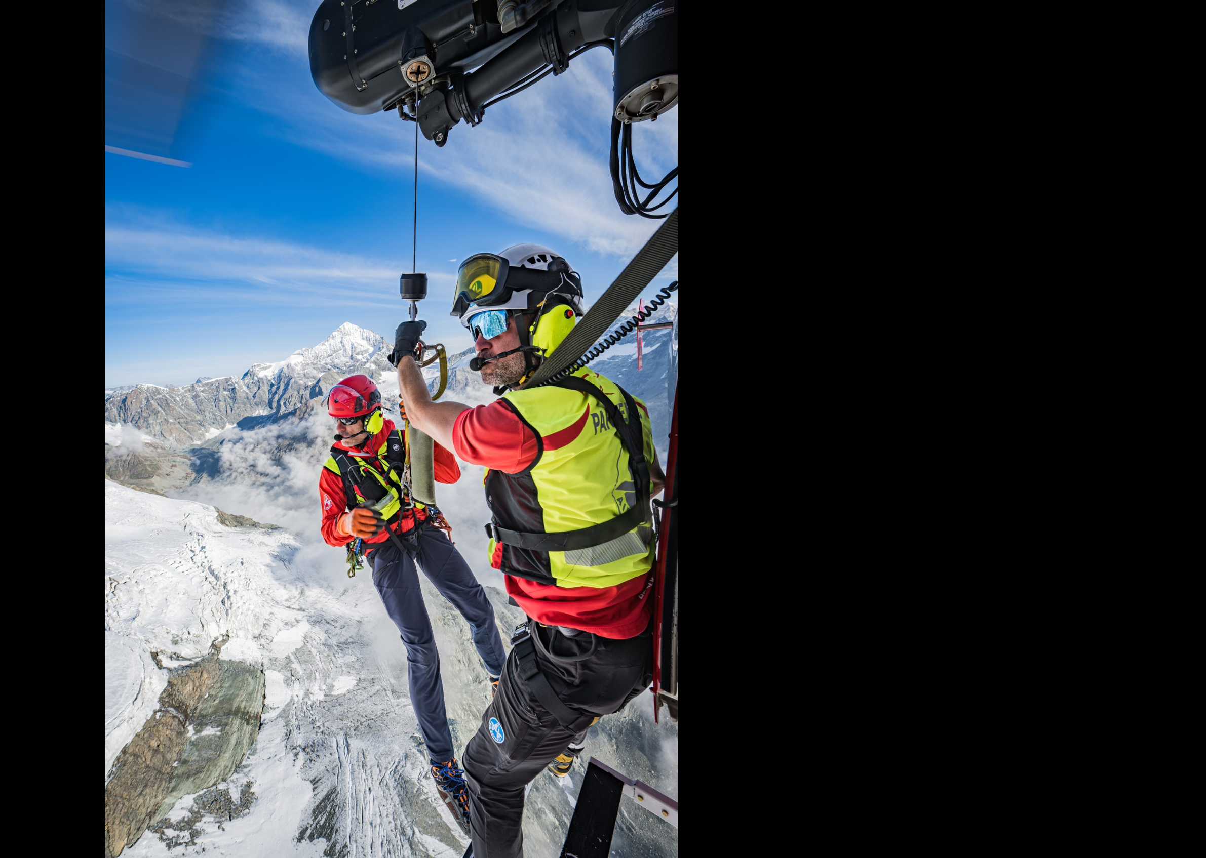 Two men are wearing helmets and harnesses while hanging from a helicopter. AI generated content
