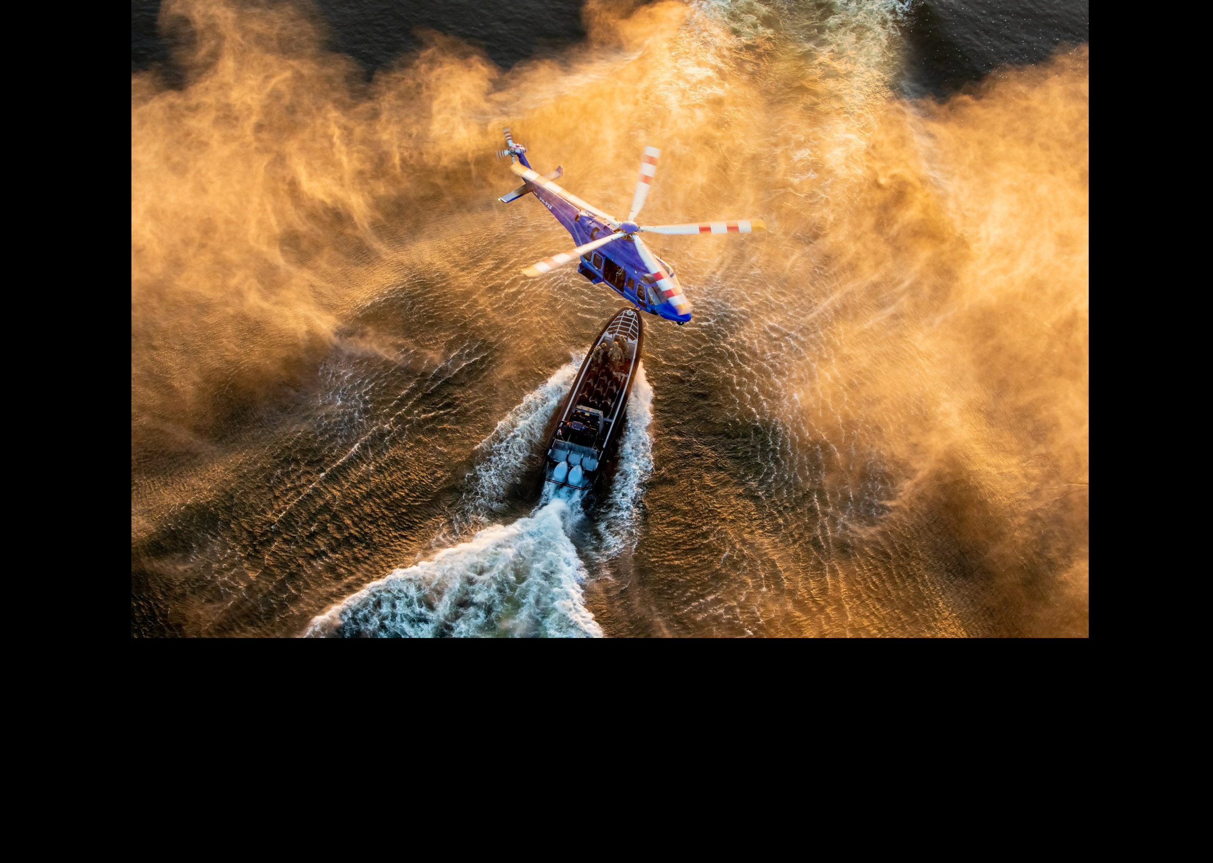 A helicopter is flying over a boat in the water. AI generated content