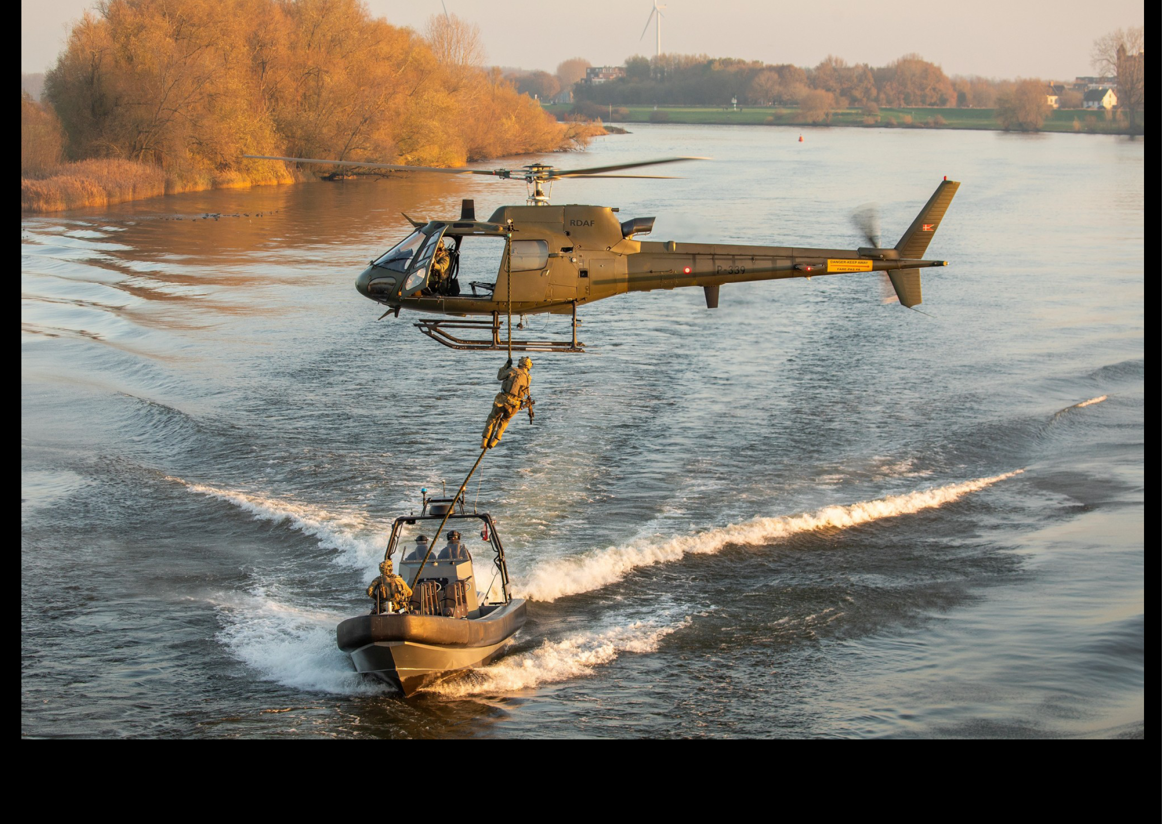 A helicopter is flying over a boat in the water. AI generated content