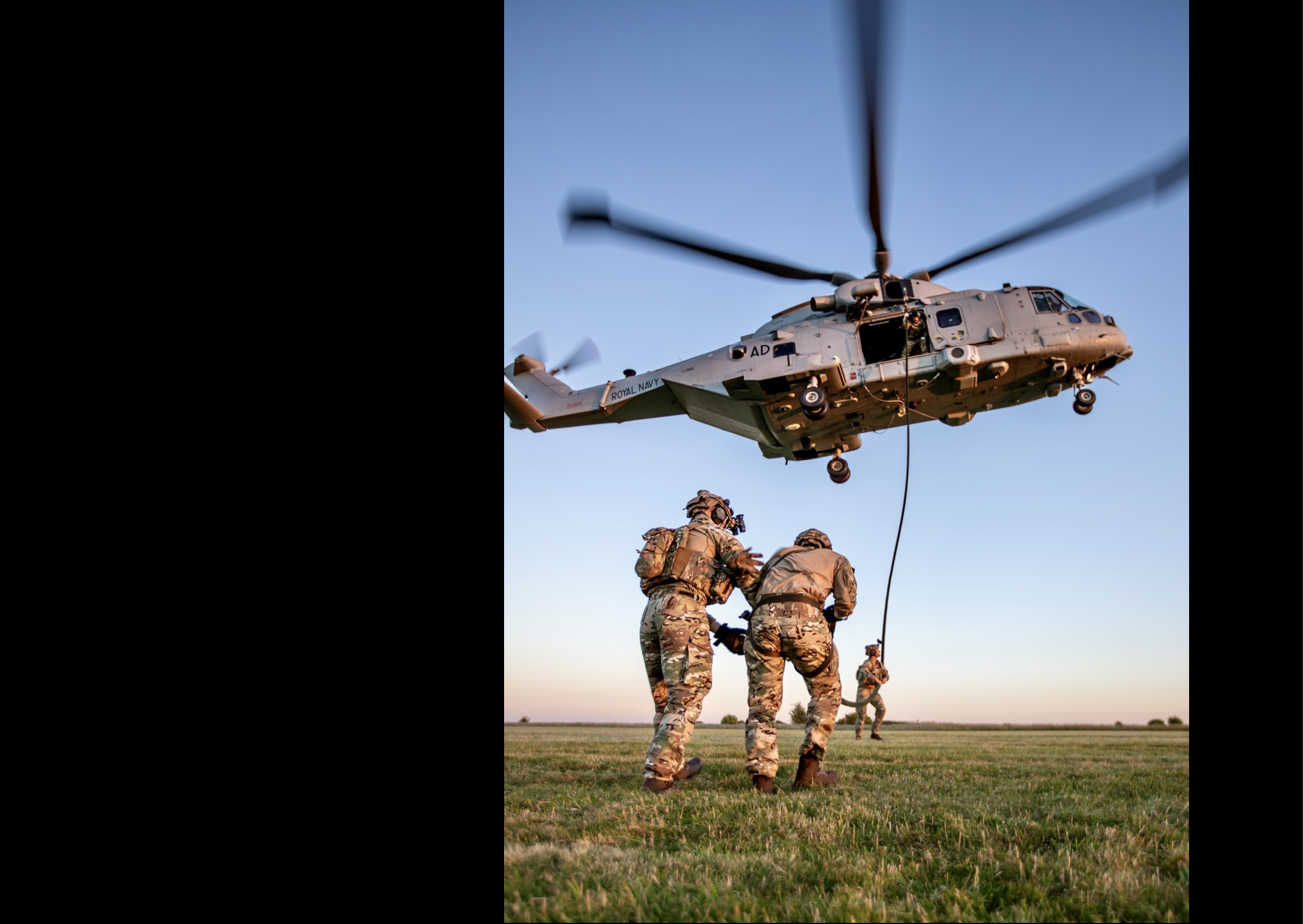 Three men are on a field, with one of them holding onto a helicopter. AI generated content