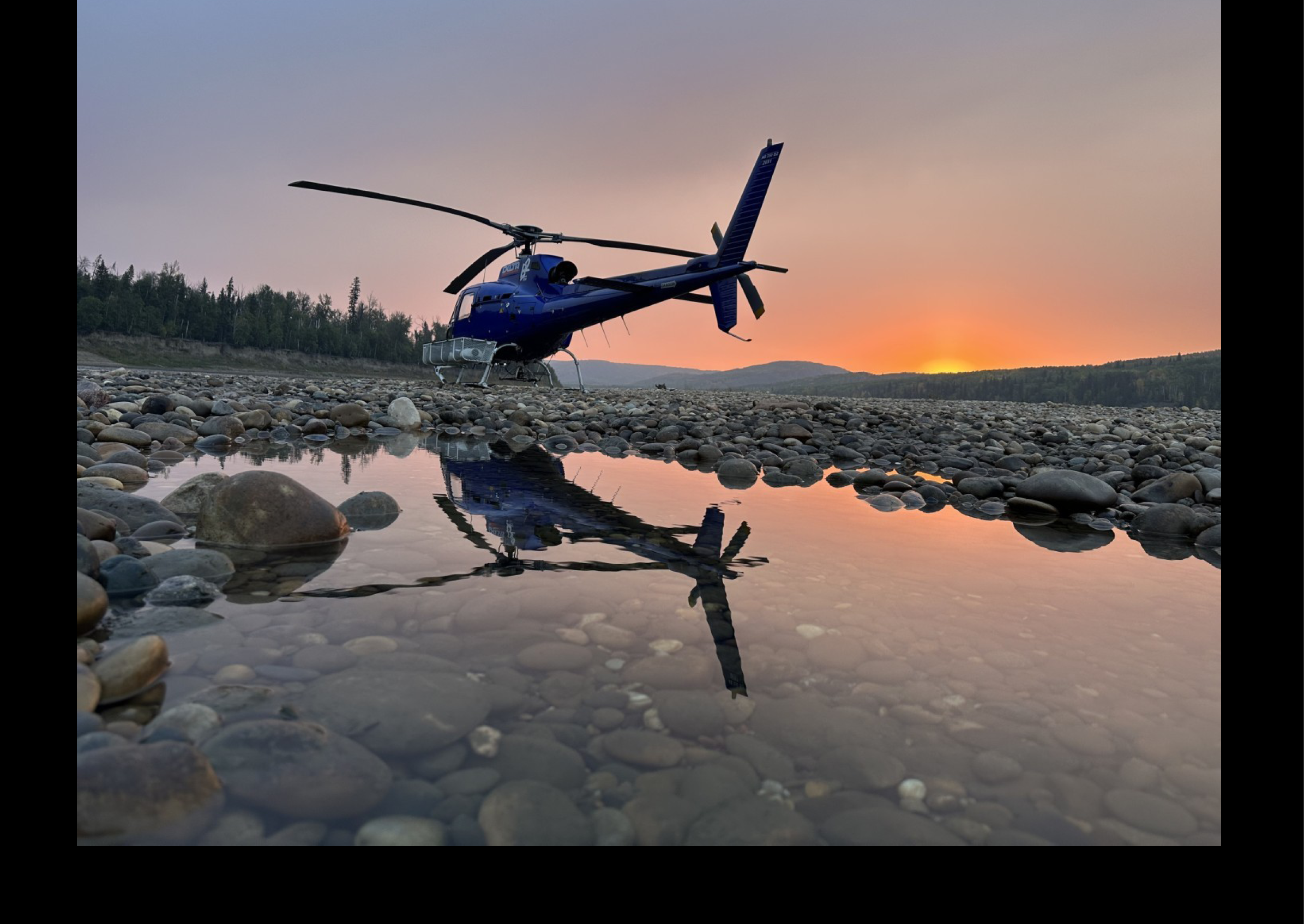 A blue helicopter is parked on a rocky beach. AI generated content