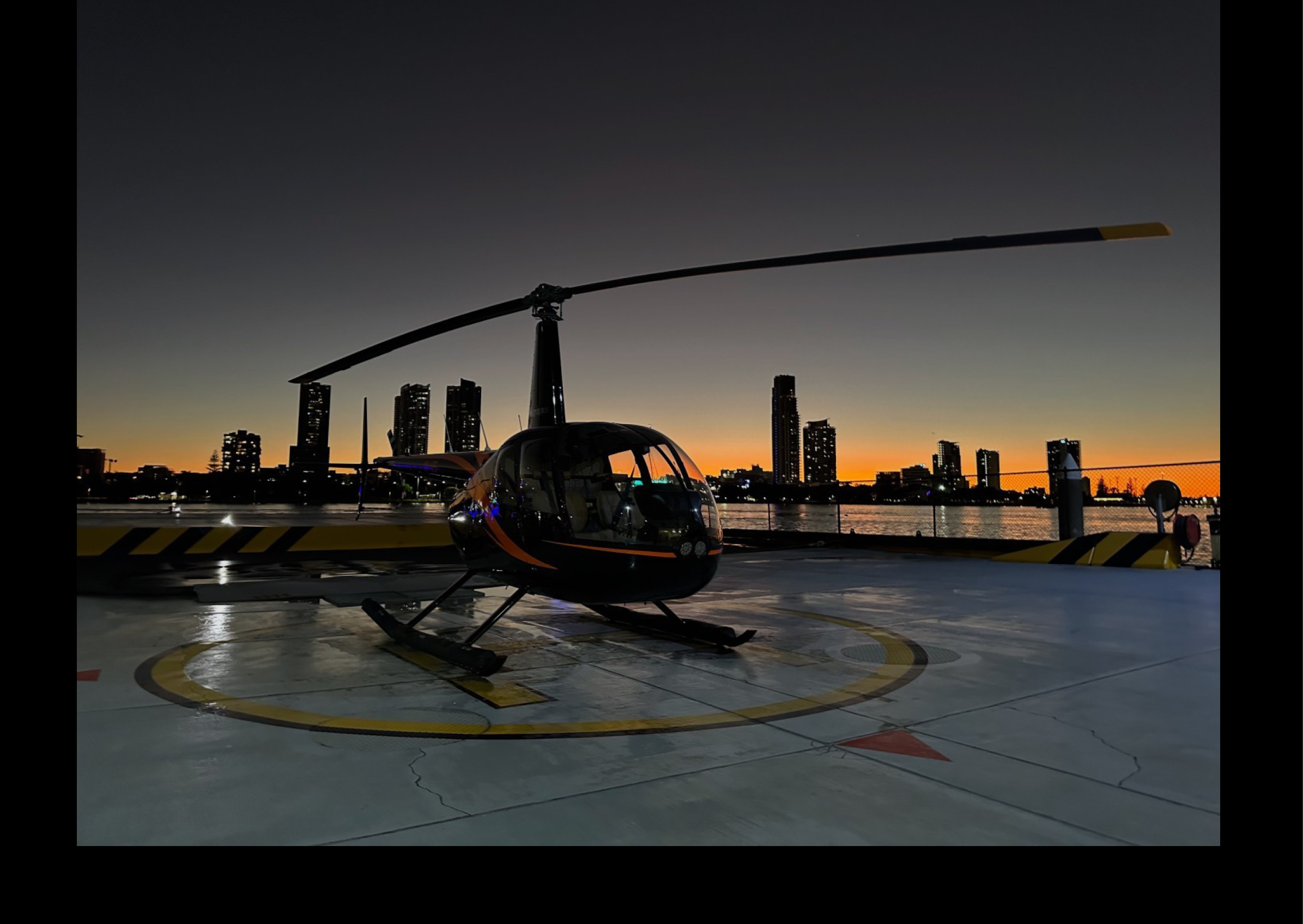 A helicopter is parked on a runway at night, with a city skyline in the background. AI generated content