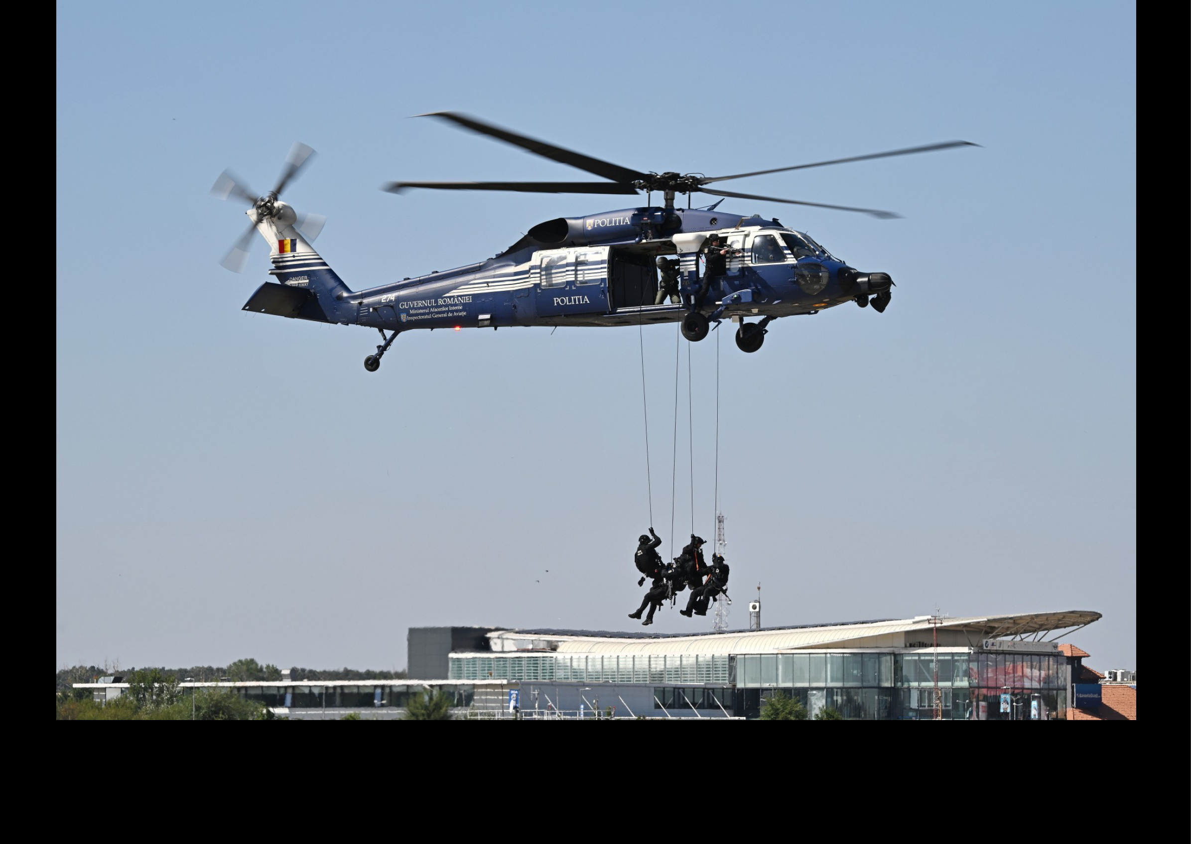 A helicopter is flying above a group of men who are hanging from a wire. AI generated content