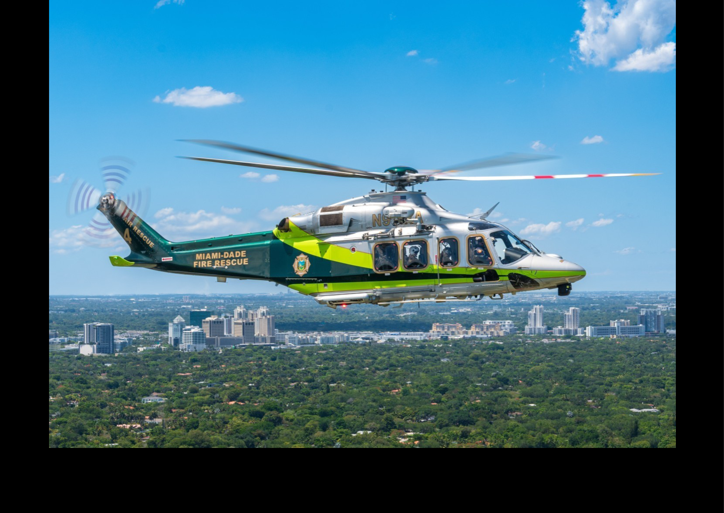 A green and white helicopter is flying over a city. AI generated content