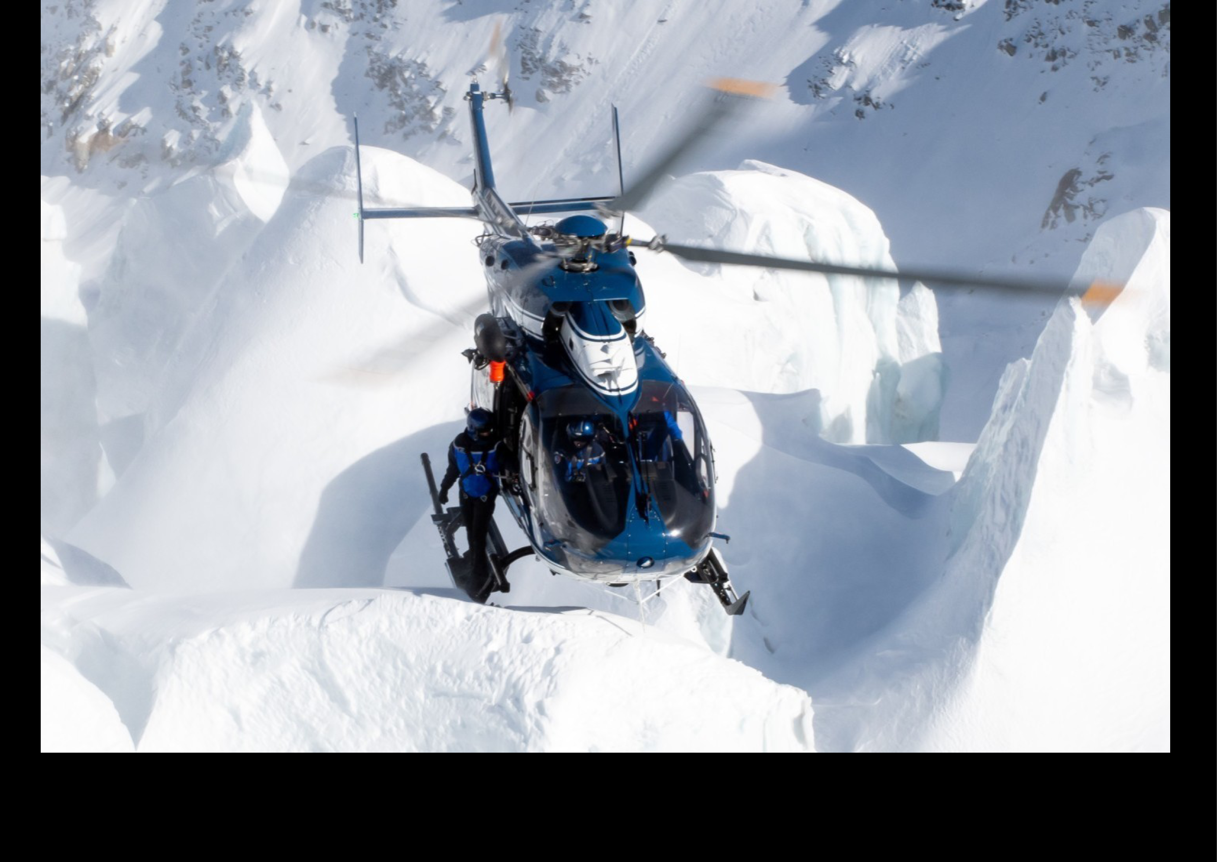A blue helicopter is flying over a snowy mountain. AI generated content