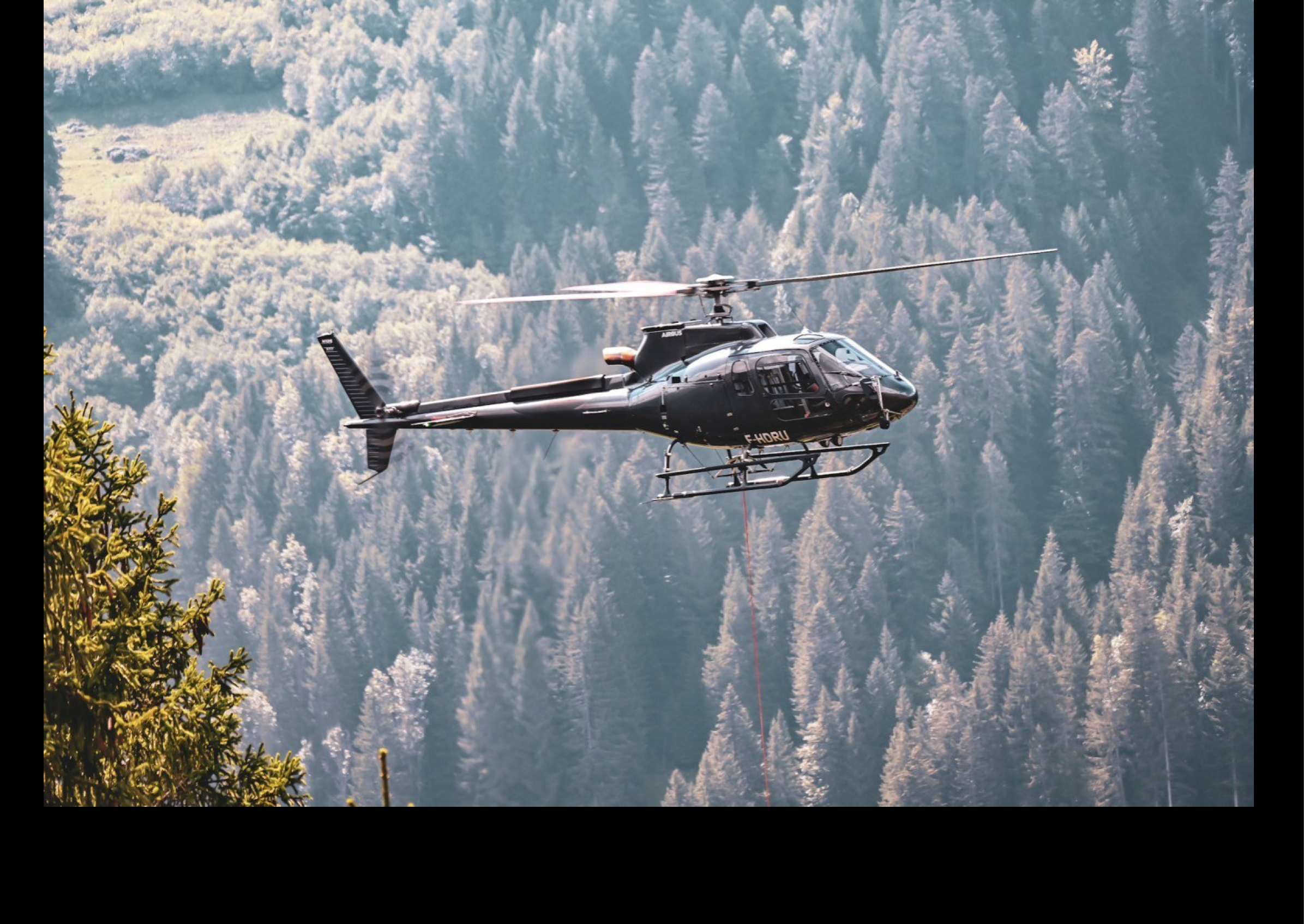 A helicopter is flying over a forest with a person hanging from a rope underneath it. AI generated content