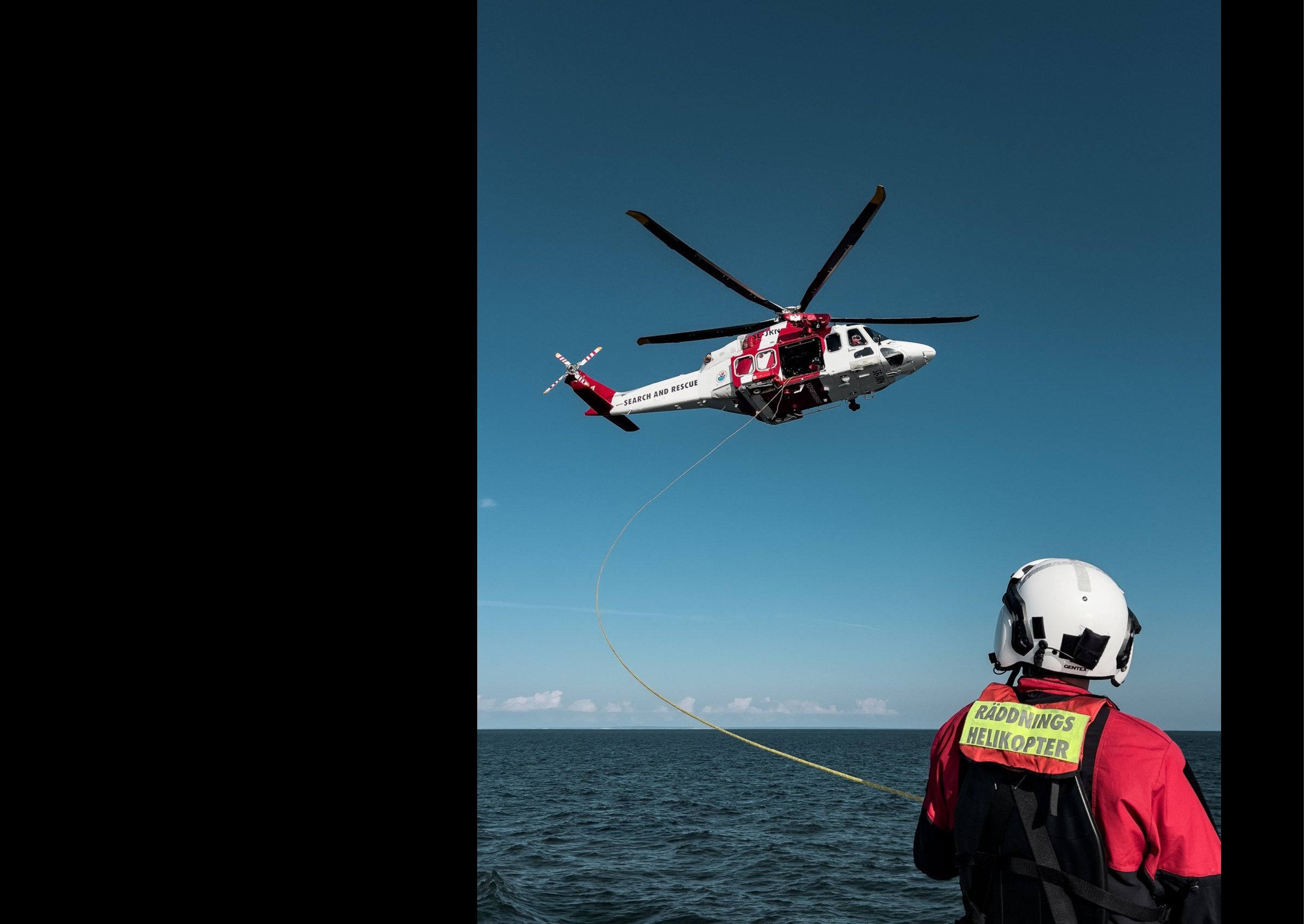 A person in a red life jacket is standing on a boat, watching a helicopter flying above. AI generated content