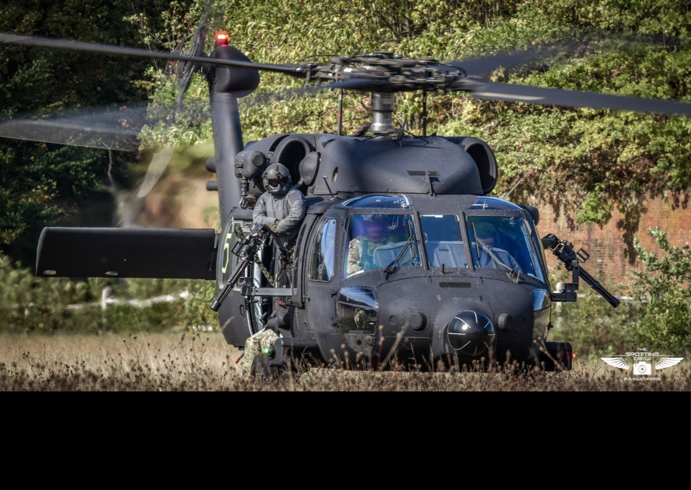 A helicopter is parked in a field with a man inside. AI generated content