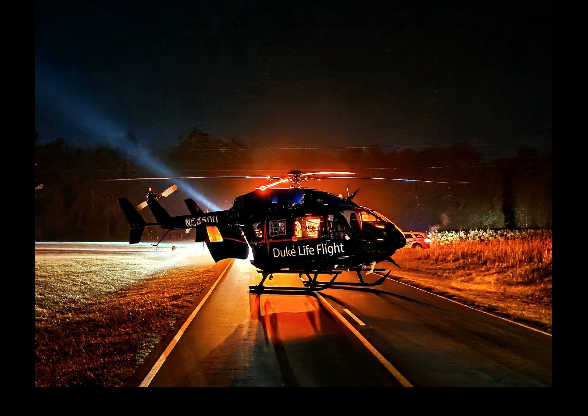 A helicopter is flying over a road at night. AI generated content