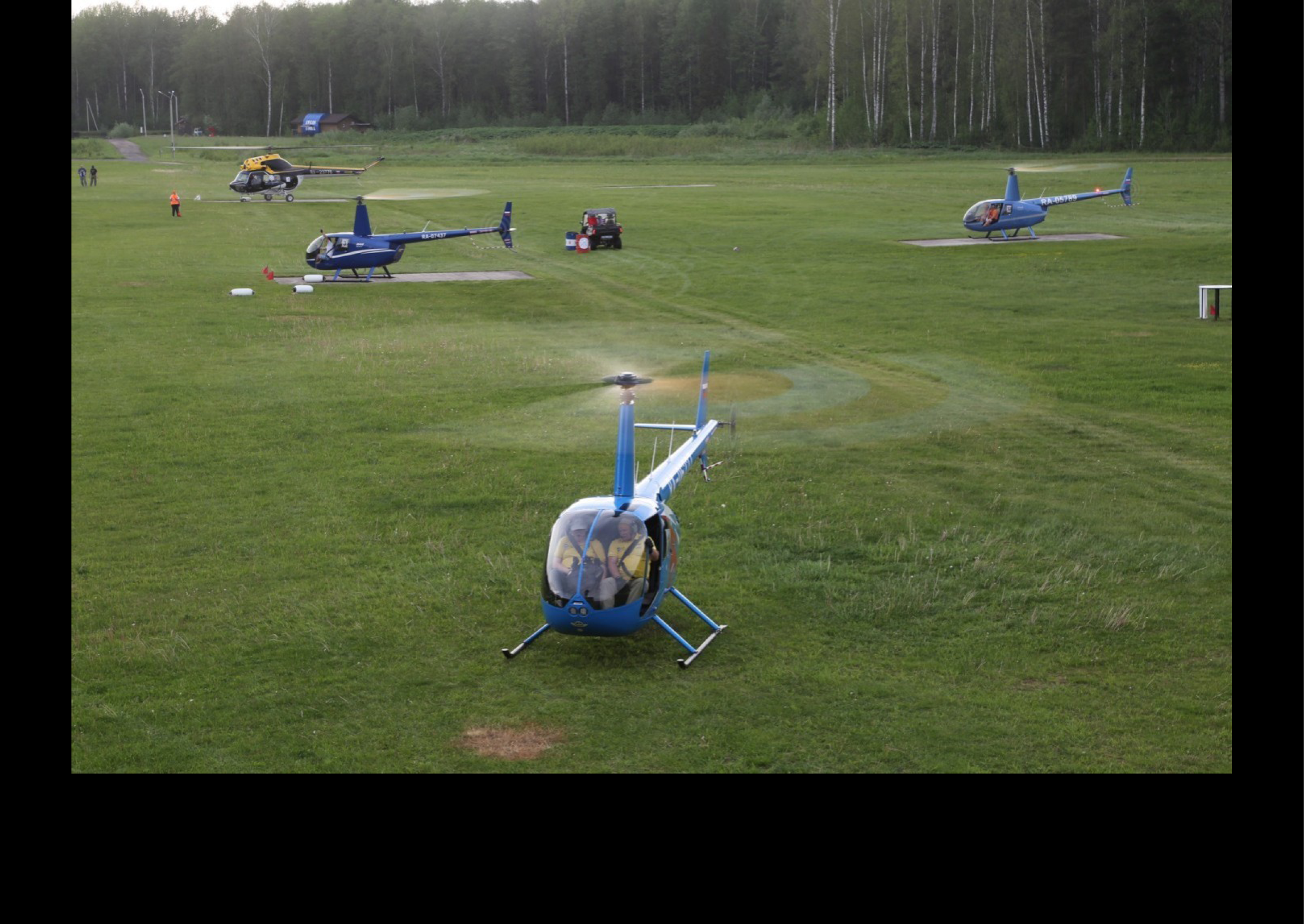 A field with several small helicopters parked on it. AI generated content