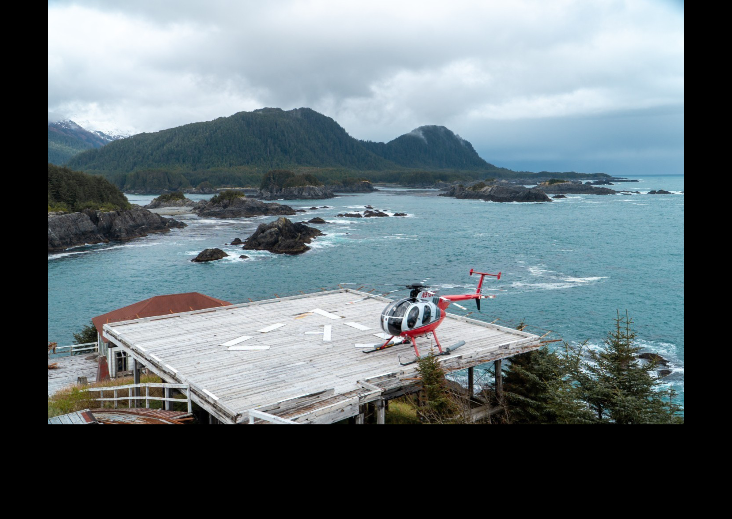 A helicopter is parked on a wooden deck in front of a house. AI generated content
