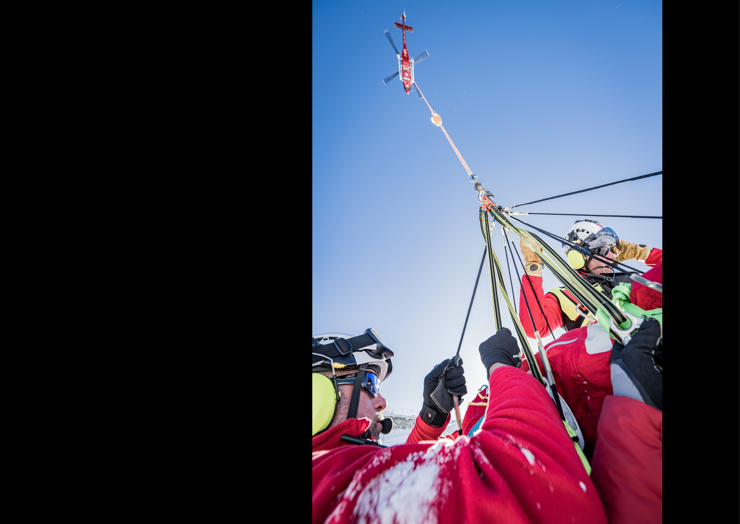 Three people are wearing red jackets and are being lifted by a helicopter. AI generated content