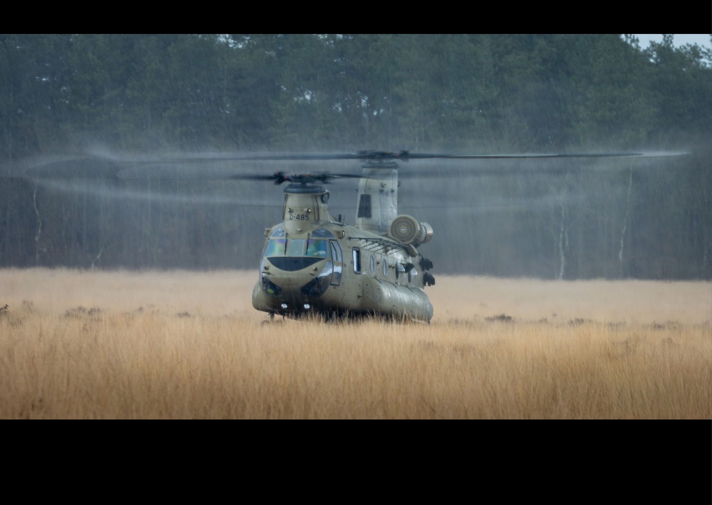 A military helicopter is flying through a field of tall grass. AI generated content