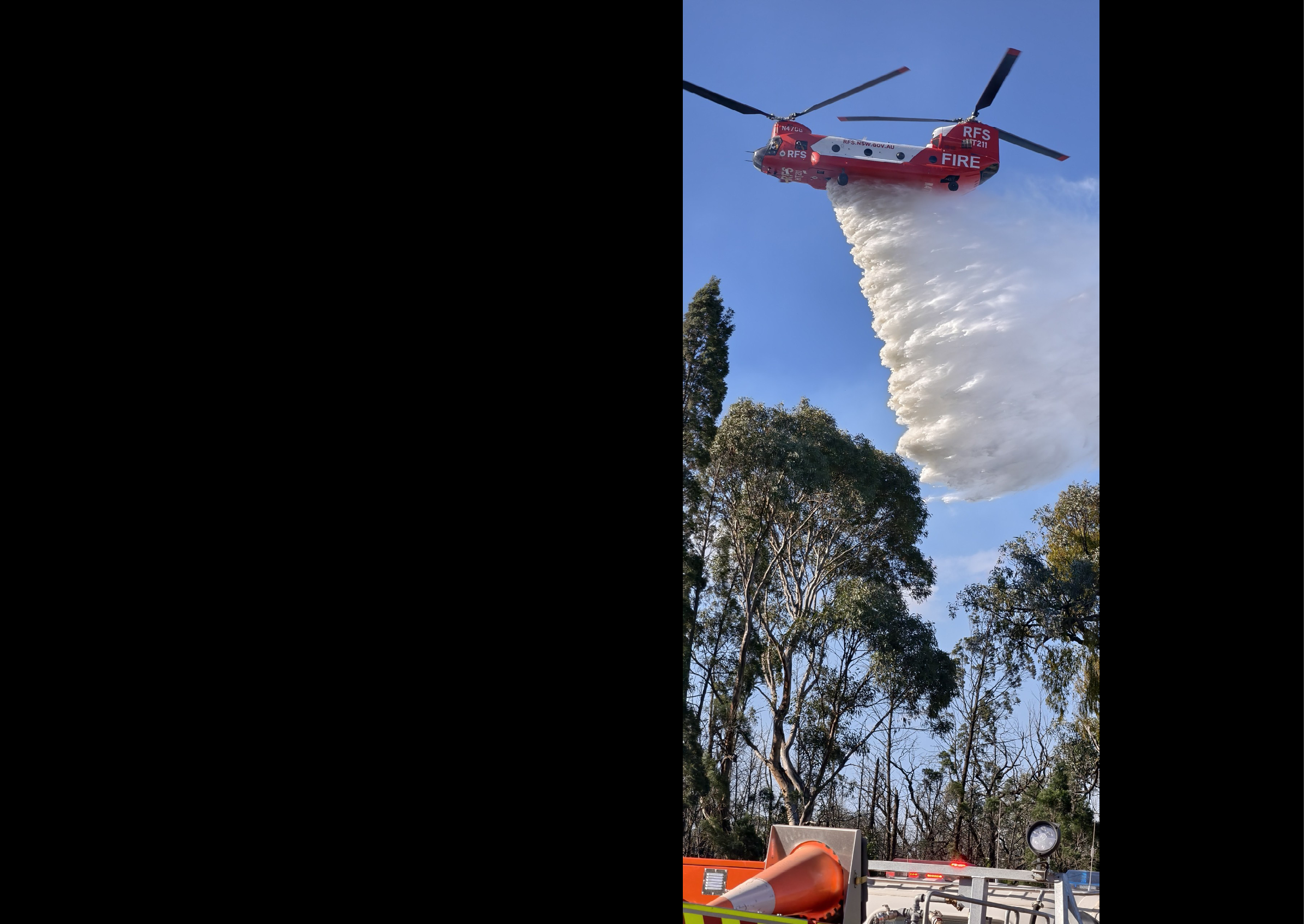 A red helicopter is spraying water on a forest. AI generated content