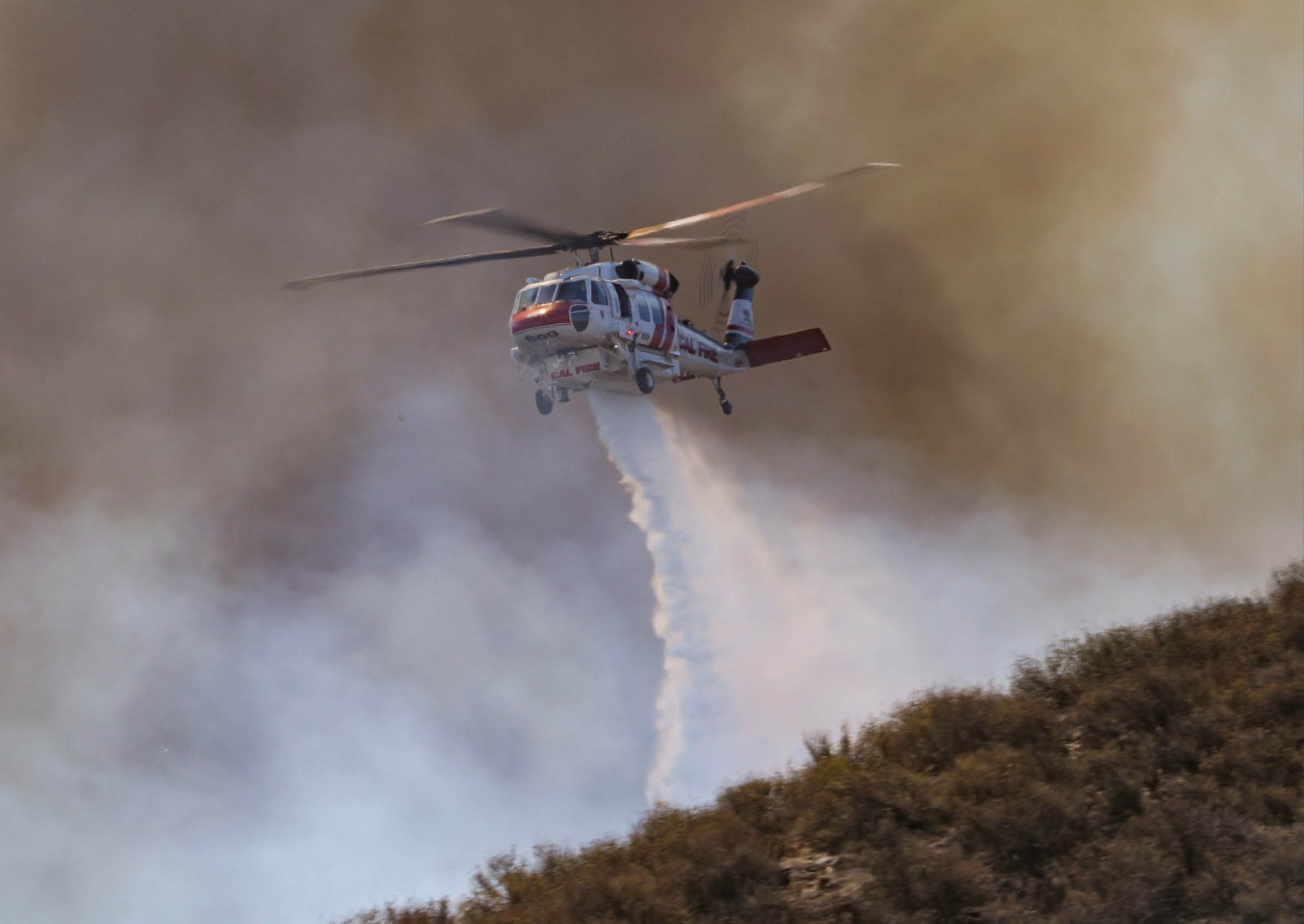 A helicopter is flying through the air and spraying water. AI generated content