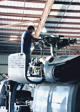 A man is working on an airplane in a hangar. AI generated content