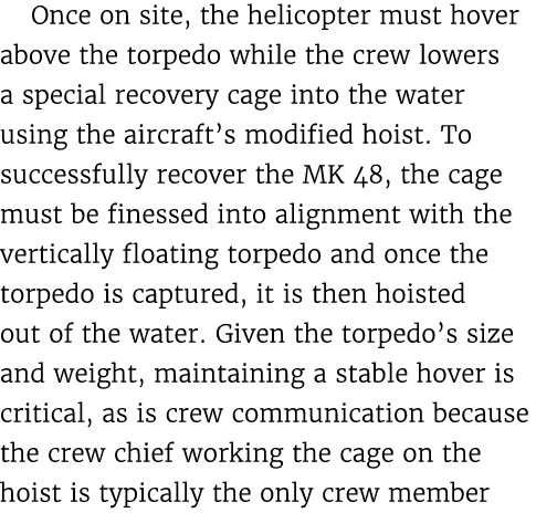 Once on site, the helicopter must hover above the torpedo while the crew lowers a special recovery cage into the wate...