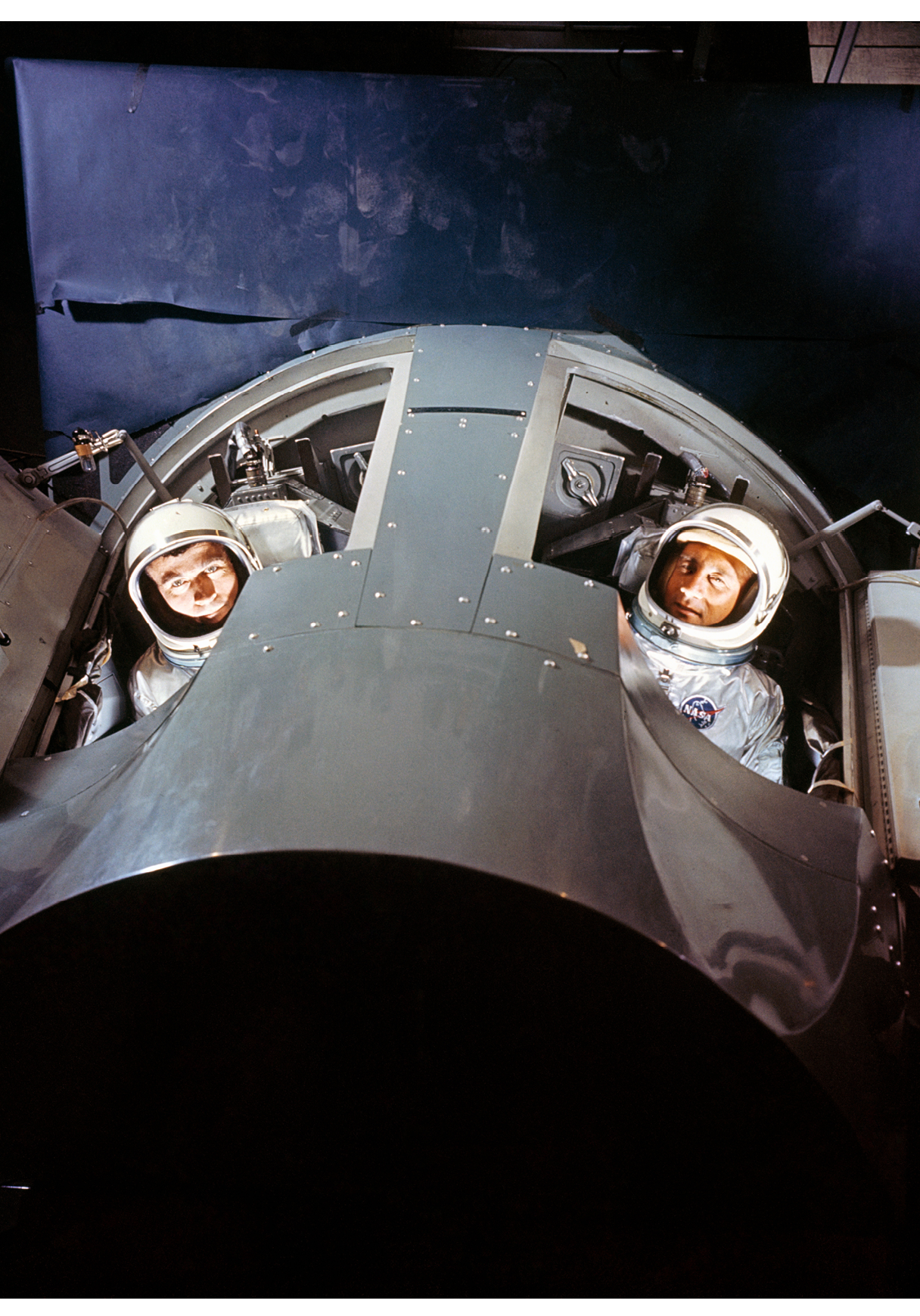 S64-25295 (March 1964) --- Astronauts Virgil I. (Gus) Grissom (right) and John W. Young, prime crew for the first manned Gemini mission (GT-3), are shown inside a Gemini mission simulator at McDonnell Aircraft Corp., St. Louis, MO. The simulator will provide Gemini astronauts and ground crews with realistic mission simulation during intensive training prior to actual launch.