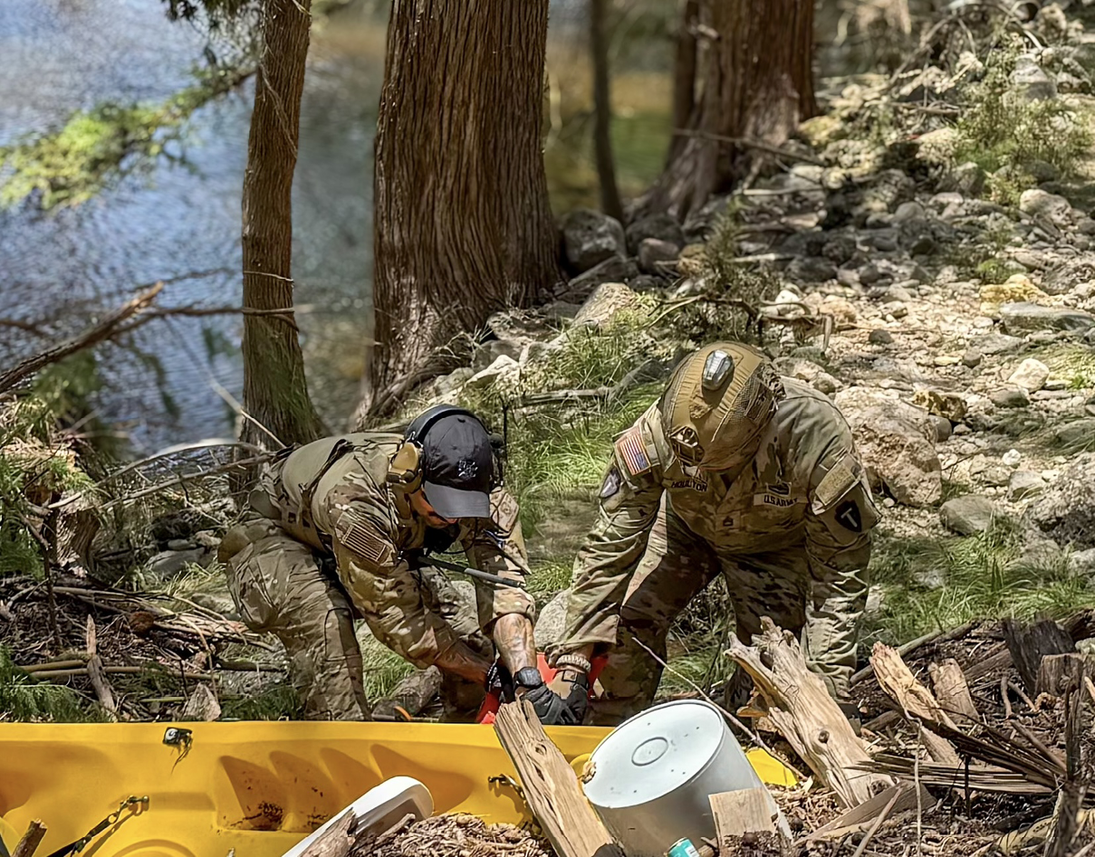 Sgt. 1st Class JJ Houlton of Delta Company, 3rd Battalion, 144th Infantry Regiment, and Staff Sgt. Marco Hernandez of the 147th Air Support Operations Squadron conduct rescue and recovery searches in response to disastrous flooding in Kerrville, Texas June 10, 2025. The Texas National Guard deployed multiple units to assist local authorities in the wake of the Central Texas floods. (U.S. Air National Guard photo by Tech. Sgt. Ryan Bennett)