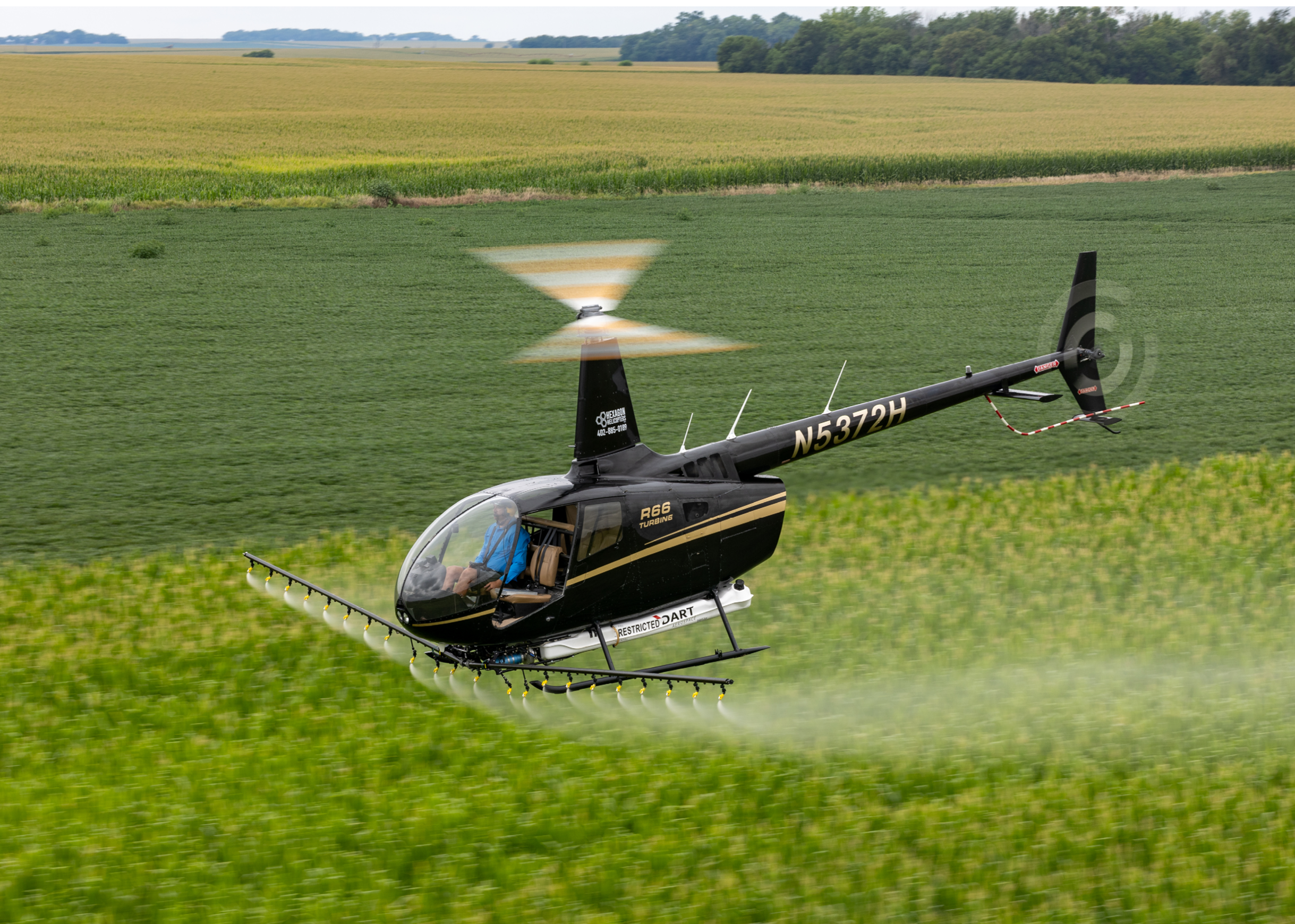 A small helicopter is flying low over a field of crops. AI generated content