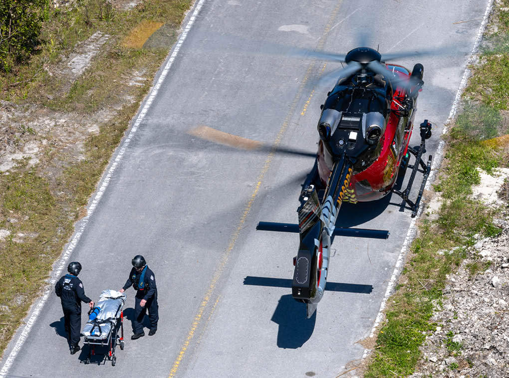 A helicopter is on the ground with people around it. AI generated content